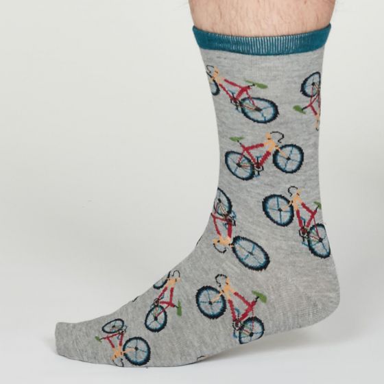 Light grey socks patterned with multi-coloured bicycles. Narrow turquoise cuff.